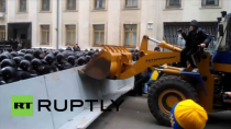 Thumbnail for Ukraine: Protesters throw flares as a digger is driven through police barricade | Ruptly