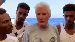 Thumbnail for Pedollywood millionaire Richard Gere boards migrant ship stuck in the Mediterranean and actively encourage illegal migration to Europe.